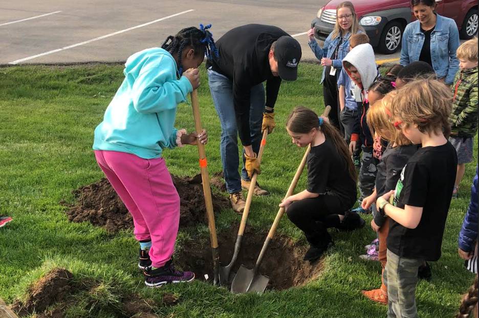Grand Rapids Christian Elementary school students planting a tree